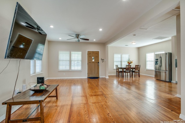 foyer with ceiling fan and light hardwood / wood-style flooring