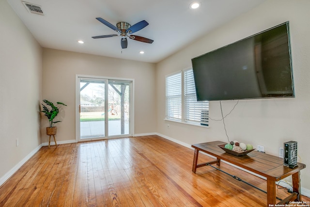 living room featuring ceiling fan and light hardwood / wood-style floors