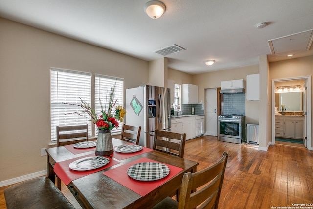 dining room with wood-type flooring and sink