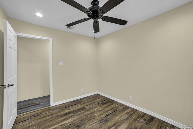 spare room featuring ceiling fan and dark hardwood / wood-style flooring