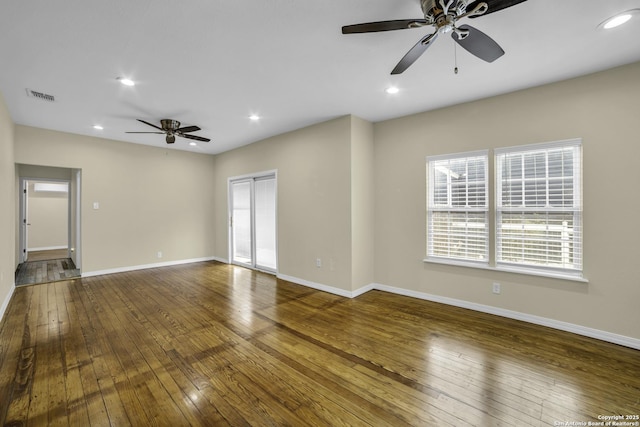 spare room featuring hardwood / wood-style flooring and ceiling fan