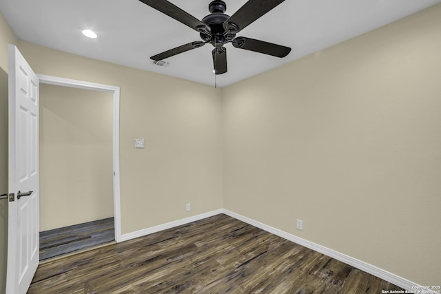 empty room with dark hardwood / wood-style flooring and ceiling fan