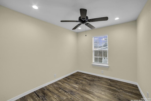 empty room with dark hardwood / wood-style flooring and ceiling fan