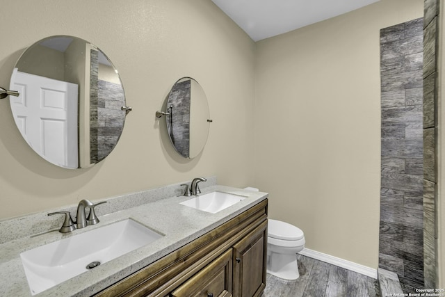 bathroom featuring vanity, hardwood / wood-style floors, and toilet