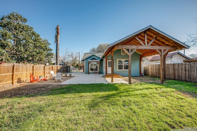 rear view of house with a yard and a patio area