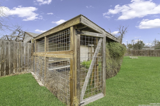 view of outbuilding with a yard