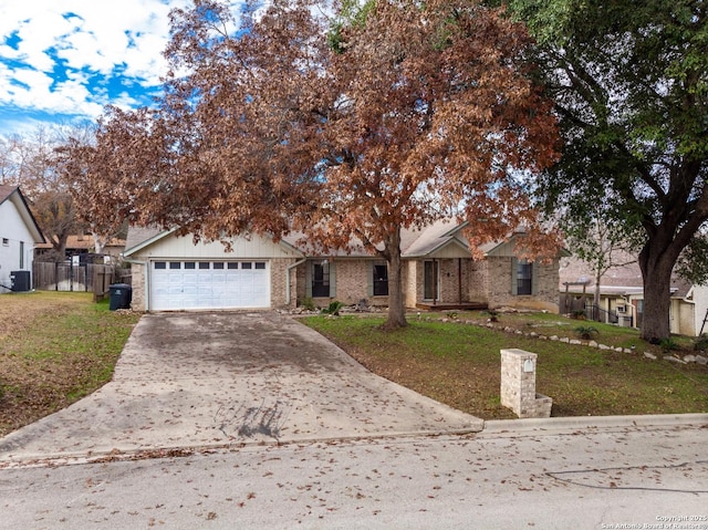 view of front of property with a garage and a front lawn