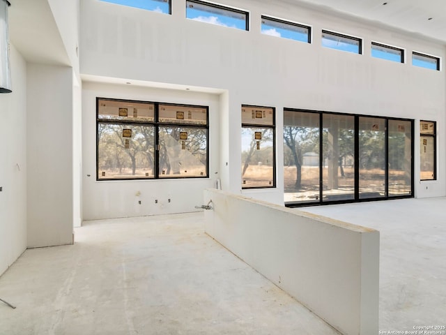 interior space with a towering ceiling and a healthy amount of sunlight