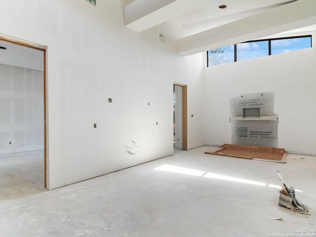 unfurnished living room with a high ceiling