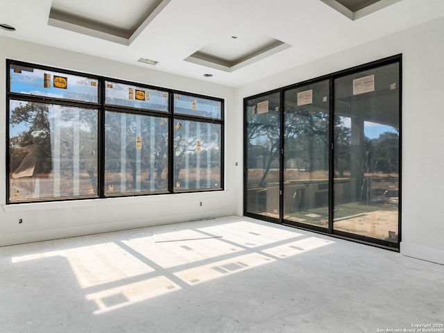 spare room featuring a tray ceiling