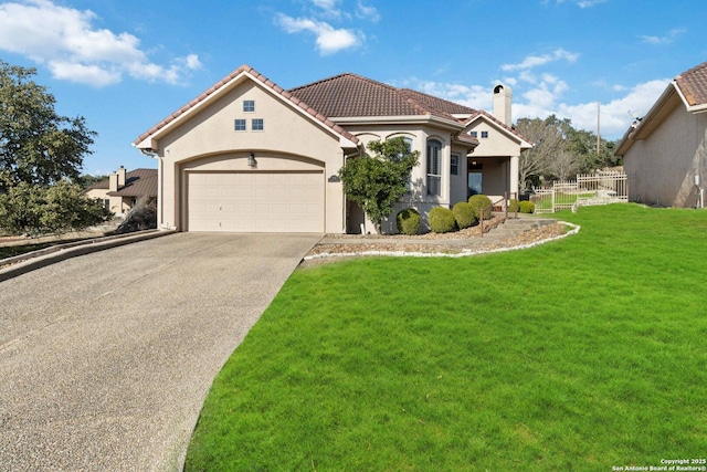 mediterranean / spanish home featuring a garage and a front yard