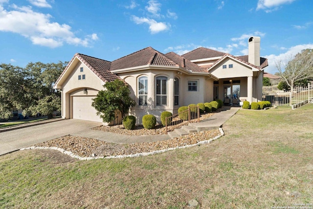 mediterranean / spanish house with a garage and a front yard