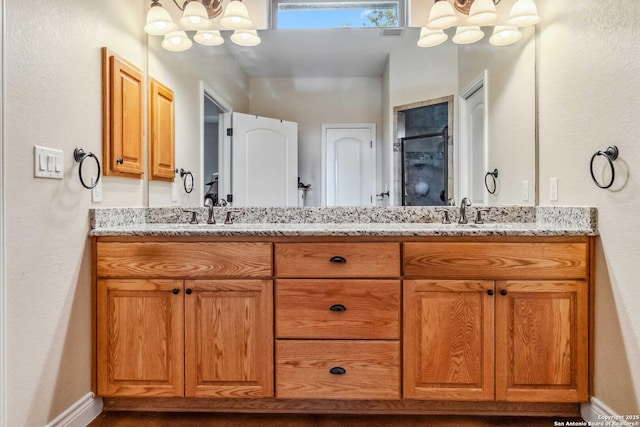 bathroom with an inviting chandelier and vanity