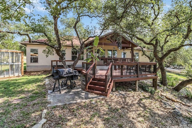 exterior space with a wooden deck and a patio area