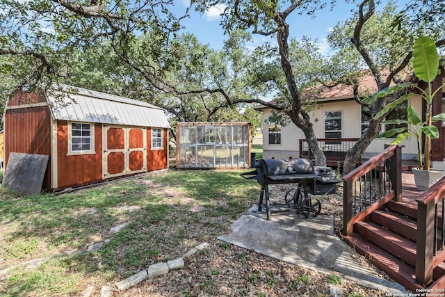 view of yard with a deck and a storage unit