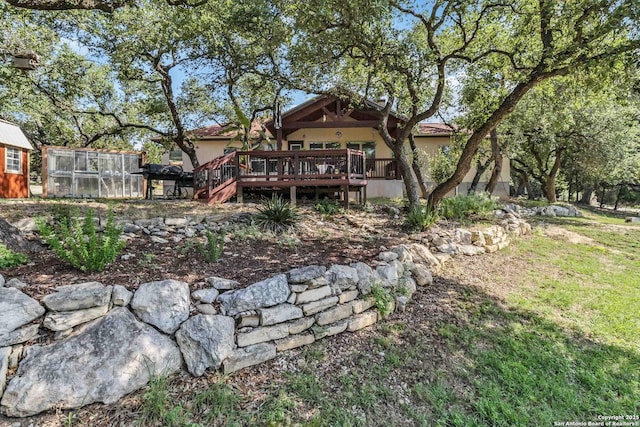 back of property featuring a deck