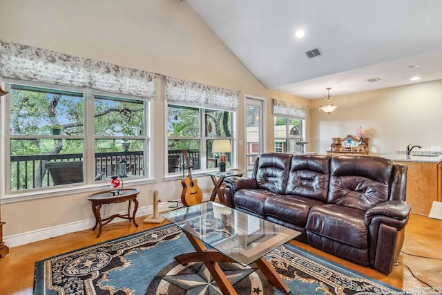 living room with sink and high vaulted ceiling