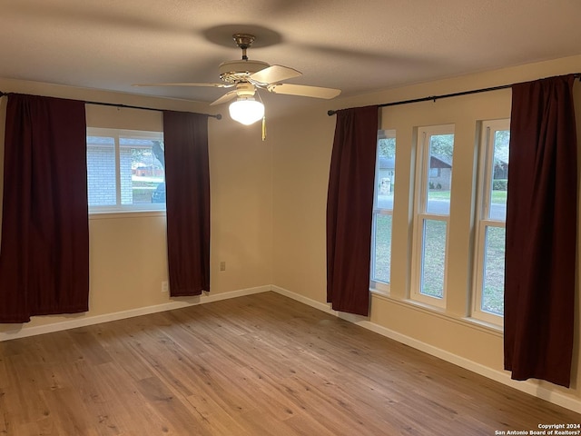 unfurnished room with ceiling fan and light wood-type flooring