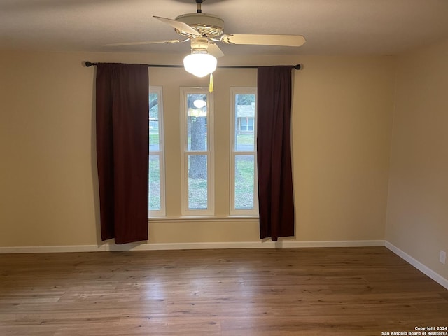 unfurnished room featuring hardwood / wood-style floors and ceiling fan