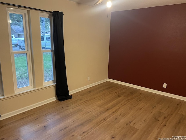 empty room with hardwood / wood-style flooring