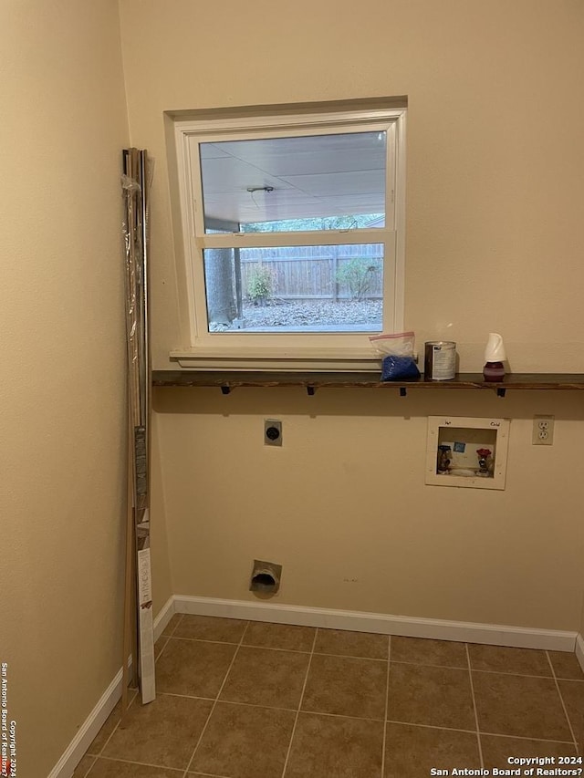 washroom with washer hookup, hookup for an electric dryer, and dark tile patterned flooring