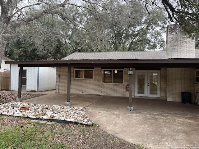 rear view of house with a carport and french doors