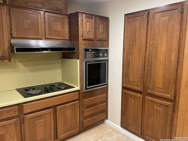 kitchen featuring light tile patterned flooring and black appliances