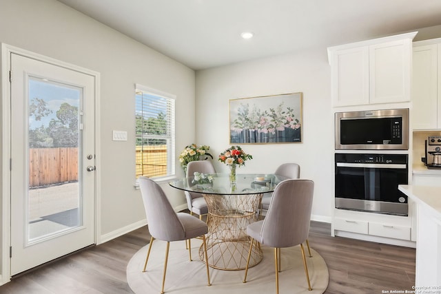 dining area with recessed lighting, wood finished floors, and baseboards