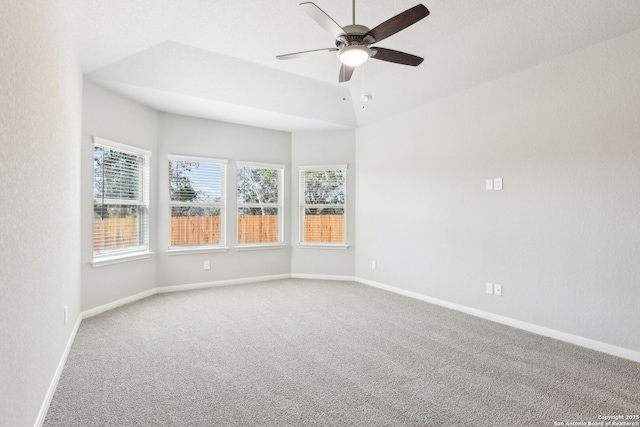 empty room featuring ceiling fan, baseboards, and carpet