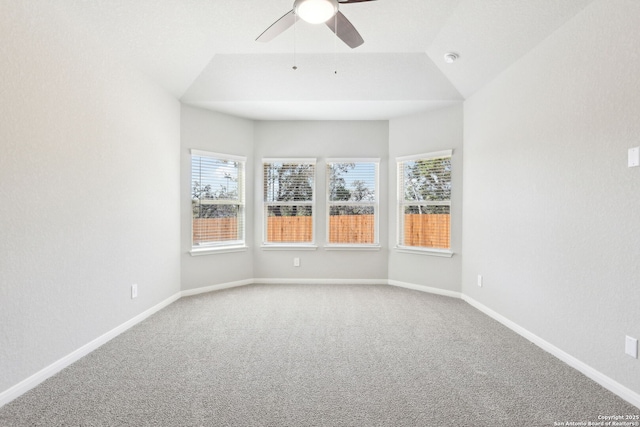 carpeted spare room with baseboards, ceiling fan, and vaulted ceiling