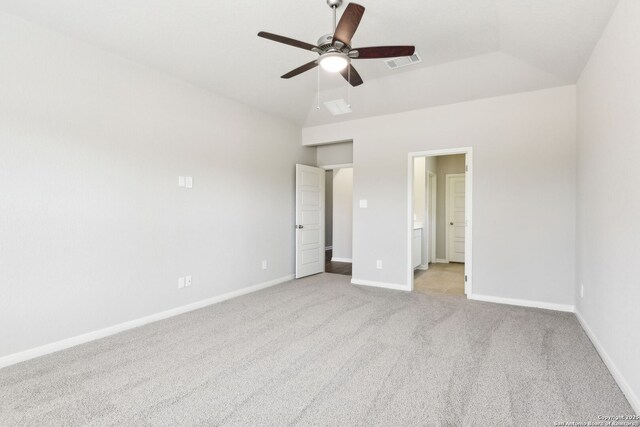unfurnished bedroom with visible vents, baseboards, lofted ceiling, and carpet floors