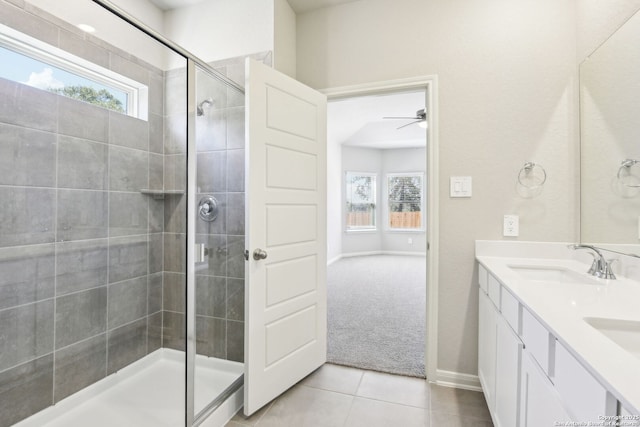 full bathroom with a stall shower, a sink, tile patterned flooring, double vanity, and ceiling fan