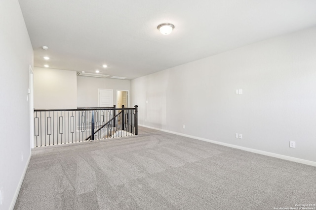 unfurnished room featuring attic access, carpet flooring, recessed lighting, and baseboards
