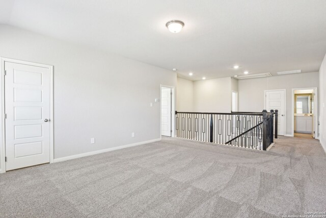 carpeted spare room with visible vents, recessed lighting, attic access, and baseboards