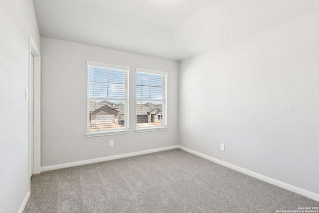 unfurnished room with baseboards and carpet floors