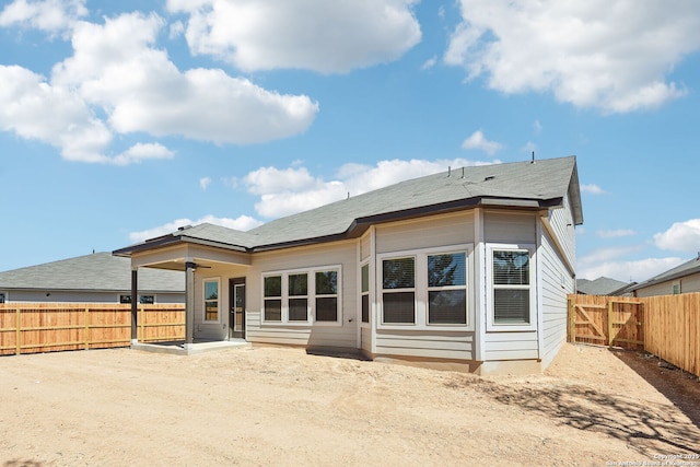 back of house with a fenced backyard and a patio area