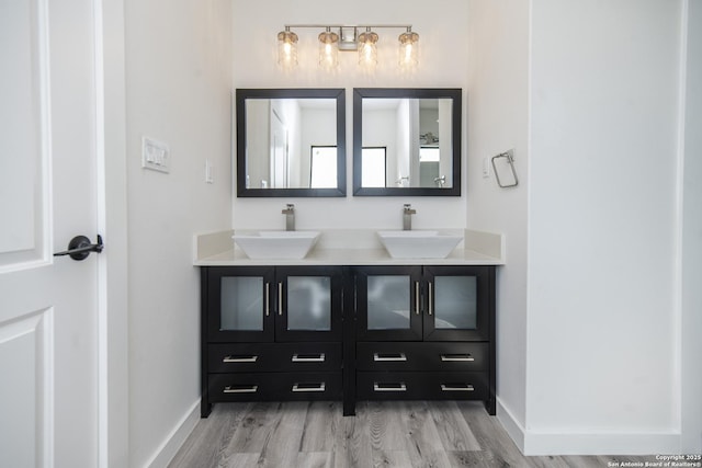 bathroom with vanity and wood-type flooring