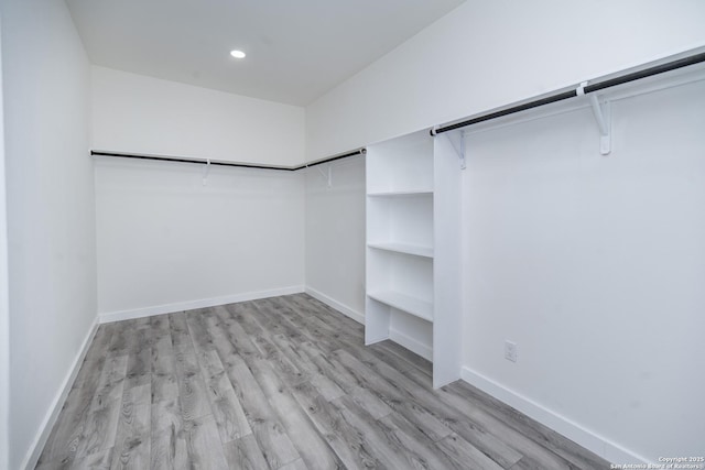 spacious closet with light hardwood / wood-style floors