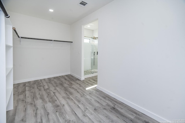 walk in closet featuring light hardwood / wood-style floors