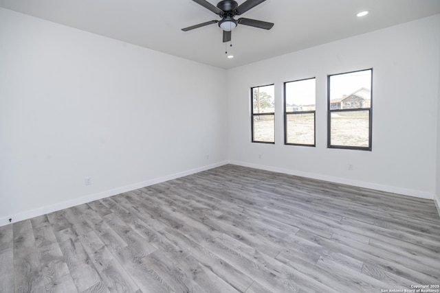 empty room featuring ceiling fan and light wood-type flooring