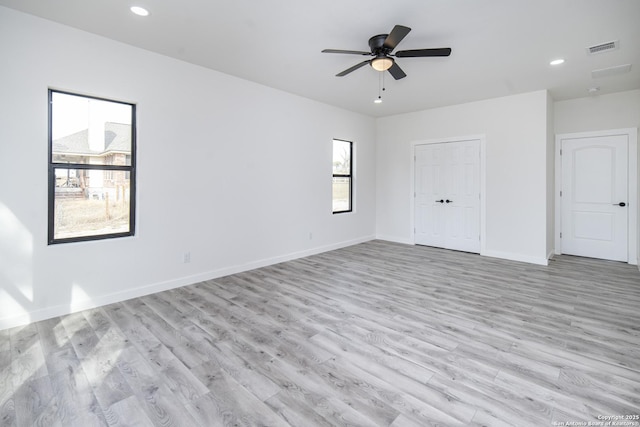 empty room featuring ceiling fan and light wood-type flooring