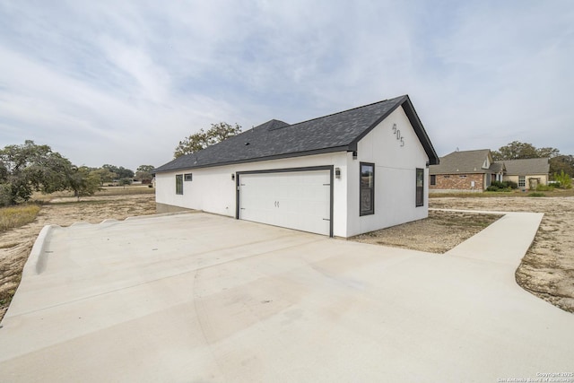 view of side of property with a garage