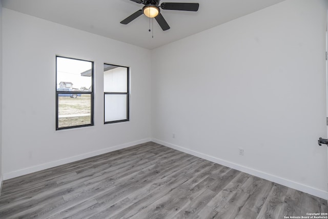 spare room featuring ceiling fan and light hardwood / wood-style flooring