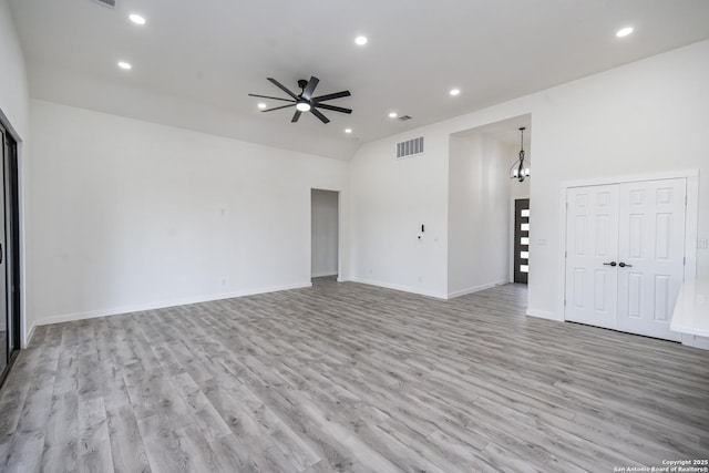 empty room featuring lofted ceiling, light hardwood / wood-style flooring, and ceiling fan