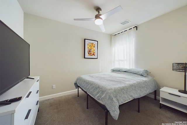 bedroom with ceiling fan and dark carpet
