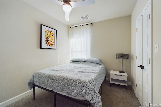 carpeted bedroom with ceiling fan and a closet