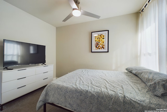 bedroom with ceiling fan and dark colored carpet
