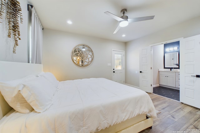 bedroom with dark wood-type flooring, connected bathroom, and ceiling fan