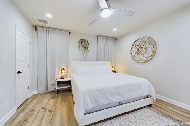 bedroom with ceiling fan and hardwood / wood-style floors
