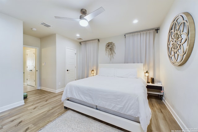 bedroom with light hardwood / wood-style floors and ceiling fan